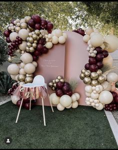 an outdoor area with balloons, chairs and a sign that says love is in the air