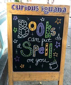 a chalkboard sign with writing on it in front of a storefront window that says 80k's can put spell on you