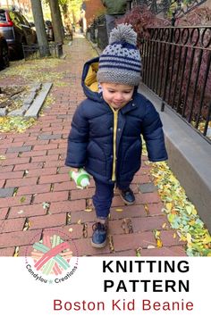 a little boy walking down a sidewalk wearing a blue jacket and hat with the words knitting pattern boston kid beanie written on it