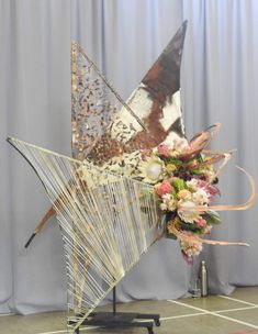 a large metal sculpture with flowers on it