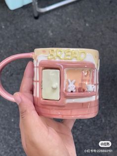 a person holding a coffee mug with the word bread on it