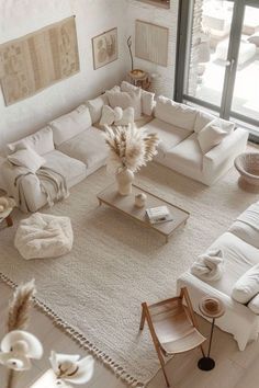 an aerial view of a living room with white furniture