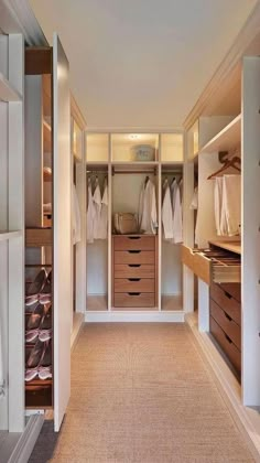 an empty walk in closet with lots of drawers