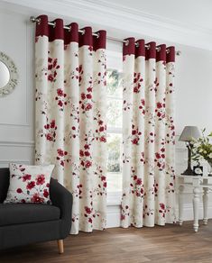 a living room with red and white curtains