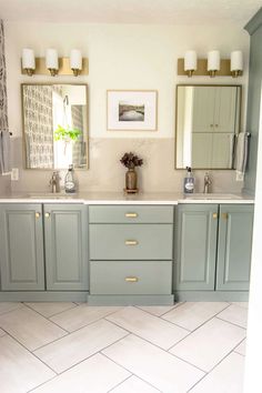 a bathroom with double sinks and two mirrors