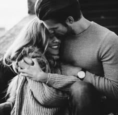 black and white photograph of a couple cuddling