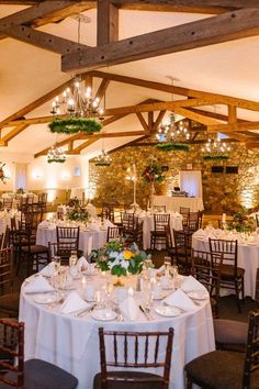 the tables are set with white linens and place settings for an elegant wedding reception