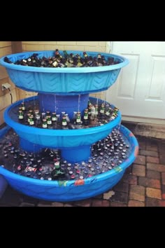 an image of a three tiered fountain made out of plastic cups and bottles on the bottom