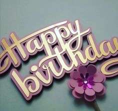 a happy birthday cake topper with a flower in the center on a blue background