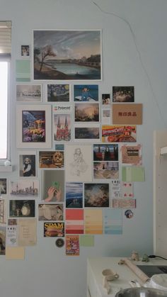 a kitchen wall covered in pictures and magnets