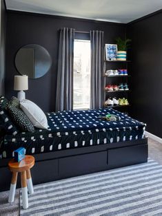 a bedroom with black walls and striped carpet