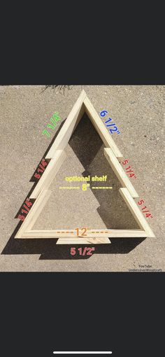 a wooden triangle with measurements on the bottom, and an area for it to be built into