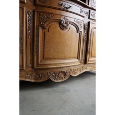 a large wooden dresser with ornate carvings on it