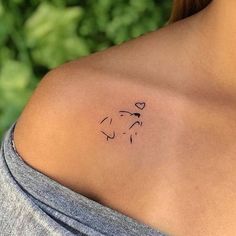 a woman with a small tattoo on her shoulder