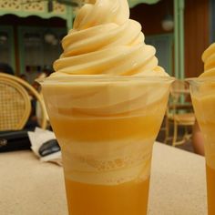 two cups filled with ice cream sitting on top of a table