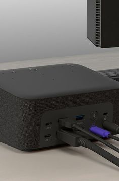 an external hard drive plugged into a laptop with two cables connected to it and attached to the side of the device