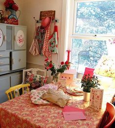 a kitchen with a table covered in cards and flowers