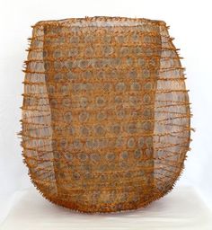 a large brown basket sitting on top of a white table