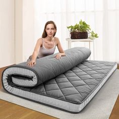 a woman laying on top of an inflatable mattress with her arms resting on it