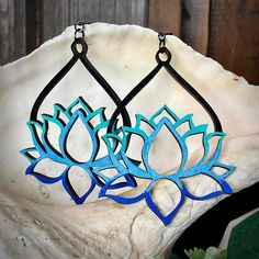 These hand-painted wood earrings are lightweight but loaded with style!  These lovely lotus flower earrings are delicate and elegant, and make a lovely gift for yourself or a nature enthusiast, botanist, or yogi you love! The body of these large 'statement' earrings (pictured in blue) measures 74mm, and with the lever back closure will hang 94mm.  The body of the smaller 'everyday' earrings (pictured in pink) measures 62mm, and with the wire will hang 85mm.  I use only nickel-free findings, and both sides of the earring are painted and sealed.  You'll receive earrings in the style and colors* as pictured, however each pair is made and painted to order, so there may be tiny differences in the pair you receive. *Colors:  Blue (black with blue ombré) or Pink (silver with pink ombré) *I am hap Matching Bridesmaids, Laser Cut Wood Earrings, Nature Enthusiast, Large Statement Earrings, Lotus Earrings, Hand Painted Gifts, Hand Painted Earrings, Painted Earrings, Hippie Earrings