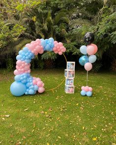 balloons are arranged in the shape of letters and numbers for an outdoor birthday party or baby shower