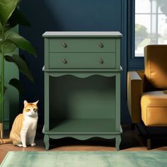 an orange and white cat sitting next to a green cabinet