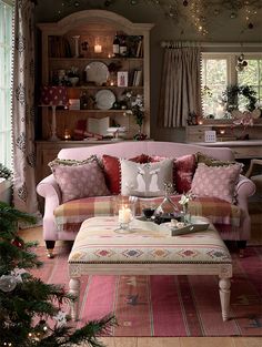 a living room filled with furniture and christmas decorations