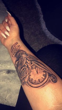 a woman's arm with a clock tattoo on it