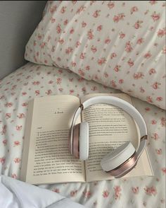 an open book with headphones on top of it