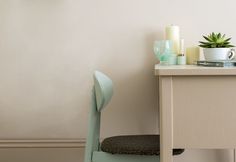 a small table with a chair next to it and a potted plant on top