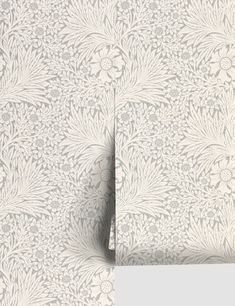 a white wallpaper with an intricate design on it's side and bottom corner