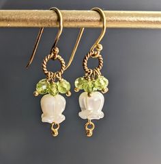 "Carved Mother of Pearl Tulip Flower and Peridot 24 K Gold Filled Wire Earrings, Gift For Her, June Birthstone  Earrings are 1 1/5\" ( 39 mm.) from top of the ear wire to the very bottom gold saucer bead.   Nice gift for her!  * Processing time is 3 - 5 days.  * US orders are shipped first class mail. * International orders are shipped first class international. * Shipping upgrades are available at checkout. Thank you for visiting my listing! Have a wonderful day!" Tulip Earrings, Birthstone Earrings, Tulip Flower, June Birthstone, Birthstone Earring, Tulips Flowers, Wire Earrings, June Birth Stone, Mother Gifts