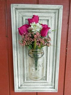 a mason jar filled with pink and white flowers