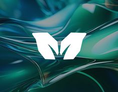 the letter m is made up of wavy green and blue material with white letters on it