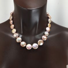 These coin pearls are special! They are solid nacre since they were tissue nucleated. They have not been bleached, so they are a soft pink/cream color and are particularly lustrous. You could wear these for the wedding and then keep wearing them! Looks great with jeans or in the office, or for the opera, and simple enough for everyday wear since it is really a neutral color. They are knotted on silk and finished with my signature beads and a handsome clasp in sterling silver. They will come pack Elegant Iridescent Pearl Necklace, Luxury Round Mother Of Pearl Necklace, Pink Pearl Necklace With High Luster, High Luster Pink Pearl Necklace, Formal Round Mother Of Pearl Necklace, Formal Pink High Luster Necklace, Formal Pink Round Pearl Necklace, Formal Pink Baroque Pearl Jewelry, Pearl Pendant Necklace In Mother Of Pearl