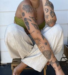 a woman with tattoos sitting on a chair