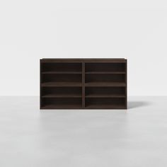 an empty bookcase sitting on top of a white floor