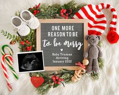 a birth announcement surrounded by christmas decorations and baby's first year items, including a teddy bear