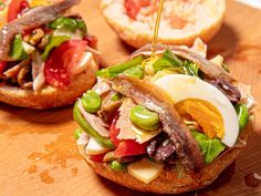 an open faced sandwich with meat and vegetables