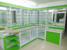 an empty store with green and white shelves