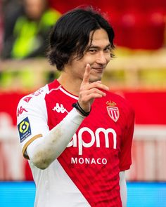 a soccer player is giving the peace sign