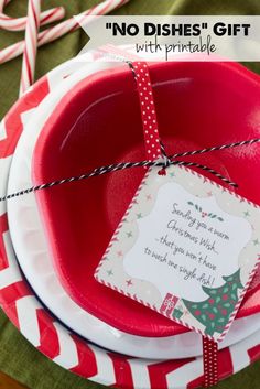 a red and white plate with a christmas gift tag on it