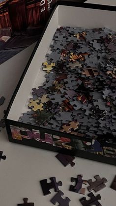 a box filled with lots of puzzle pieces