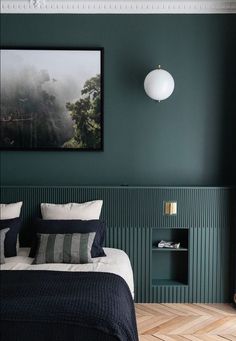 a bedroom with green walls and blue bedding