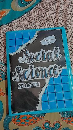 a book sitting on top of a bed covered in blue and orange sheets with the words social science