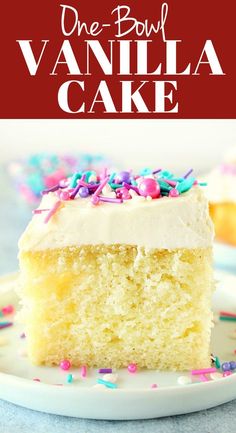 a piece of cake with white frosting and sprinkles on a plate