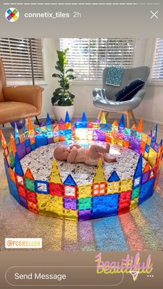 a baby laying on top of a colorful castle