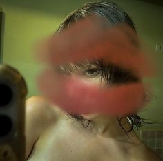 blurry photograph of a woman's face with hair blowing in front of her