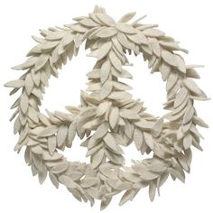 a white wreath made out of leaves on a white background