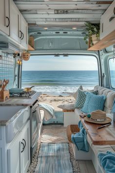 the inside of a camper van with an ocean view